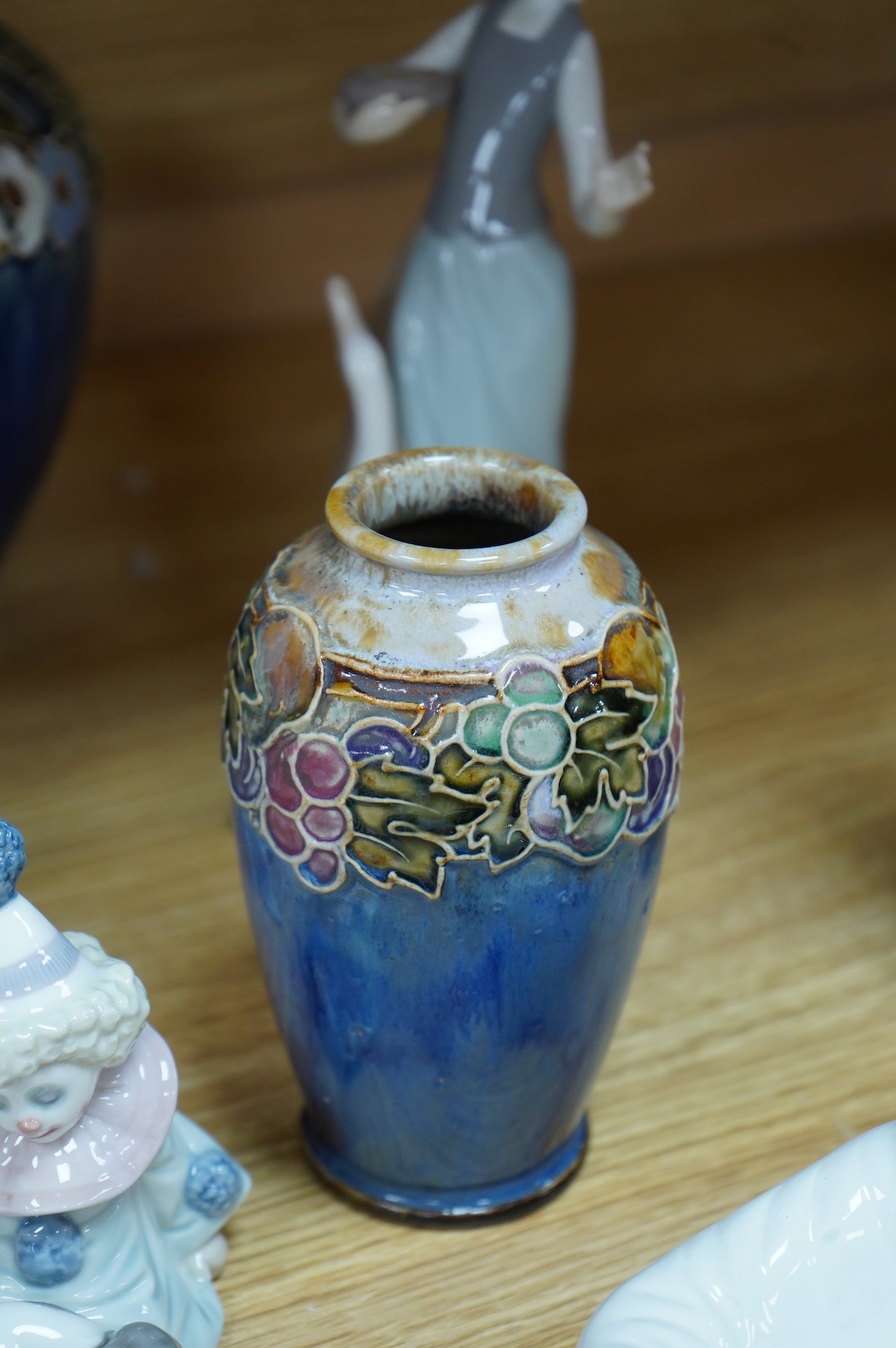 Two Doulton vases, a Casa Pupo pierrot dish and a collection of nine Lladro figures, largest 27cm high
